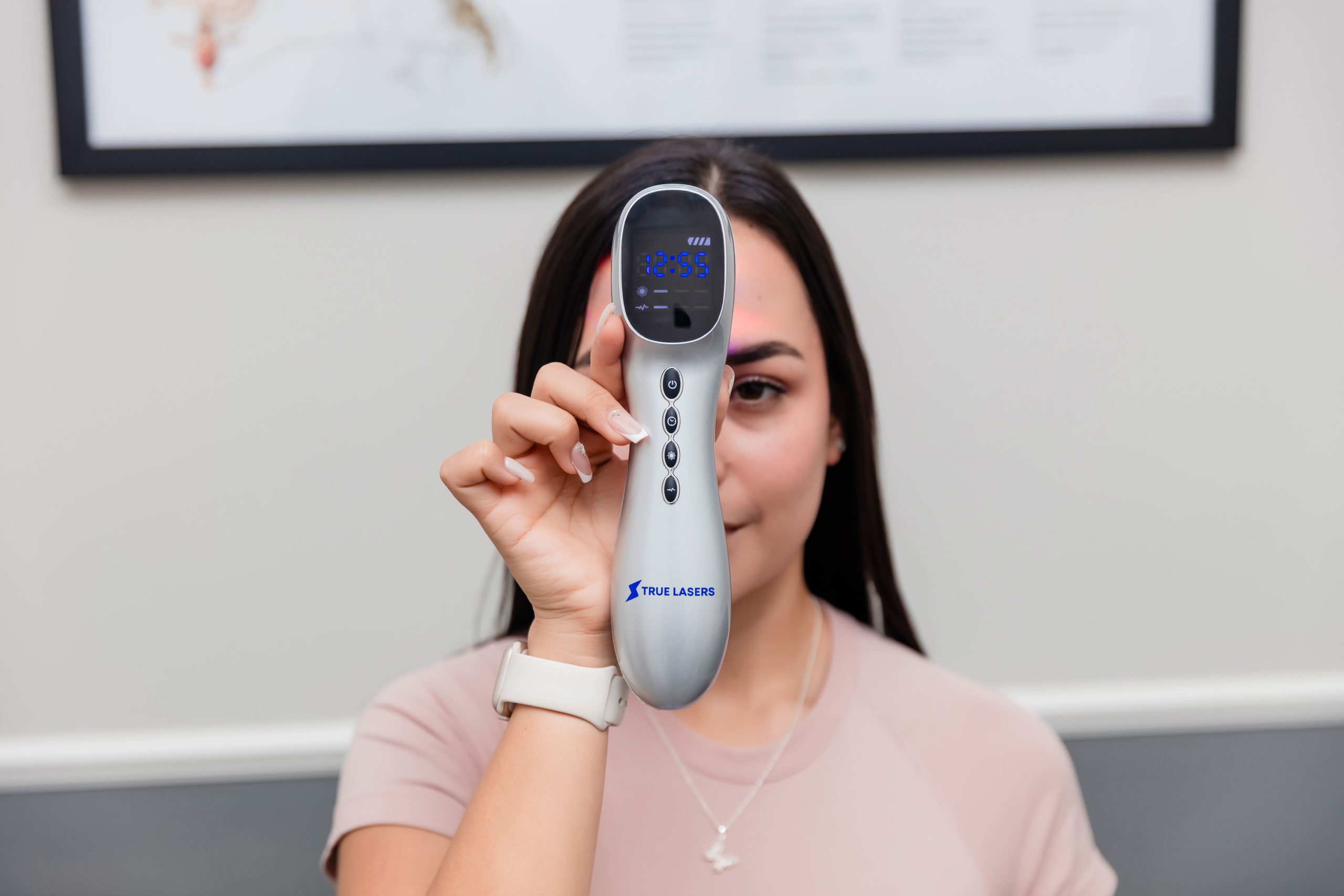 True Laser Platinum handheld photobiomodulation device shown in use